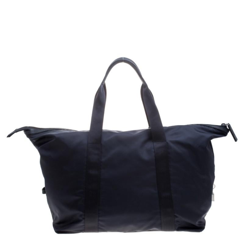 Designed to assist you on your travel sprees, this Prada Weekender bag comes crafted from nylon and styled with two top handles and the brand logo on the front. It has a spacious interior with a zip pocket and the bag is accompanied by a number