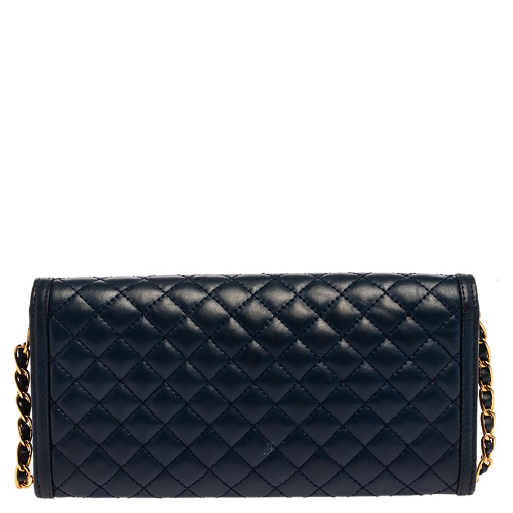 Crafted with precision from quilted leather, and touched with a navy blue shade, this wallet from Prada cannot get any luxurious than it already is! This wallet brings the brand logo in gold-tone on the flap leading to a well-designed interior