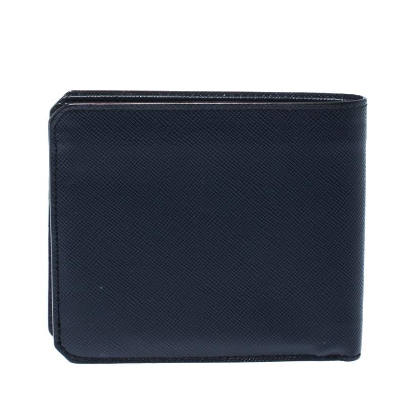 An ideal creation, this Prada wallet is a must have! It has been styled as a bifold using saffiano leather and it flaunts the brand logo on the front. The insides are leather lined and equipped with multiple card slots, an open compartment to