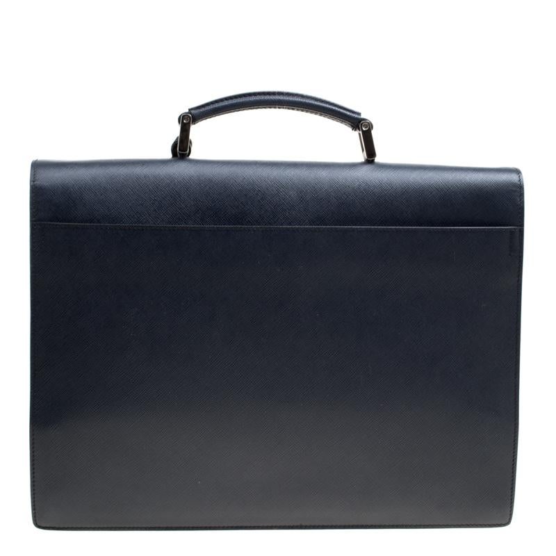 This Prada briefcase brings such a fantastic shape that you're sure to look fashionable whenever you carry it. It has been crafted from navy blue Saffiano leather and designed with one top handle, and a flap to secure the well-sized leather