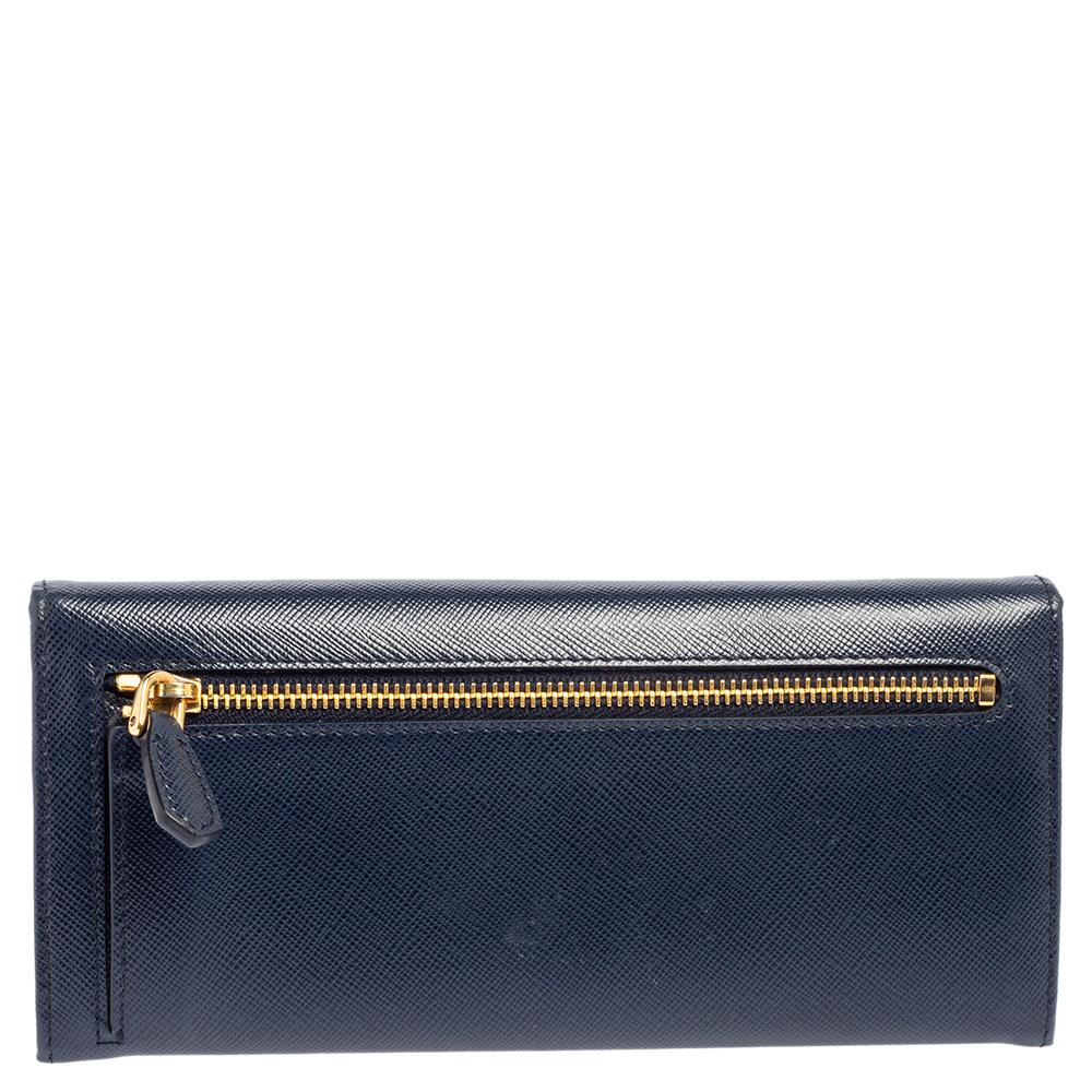 Take this spacious and functional flap wallet by Prada everywhere. Made from Saffiano Lux leather, this flap wallet is accented with a gold-tone logo. The easy to organize interior is lined with leather & fabric and features compartments, slots and