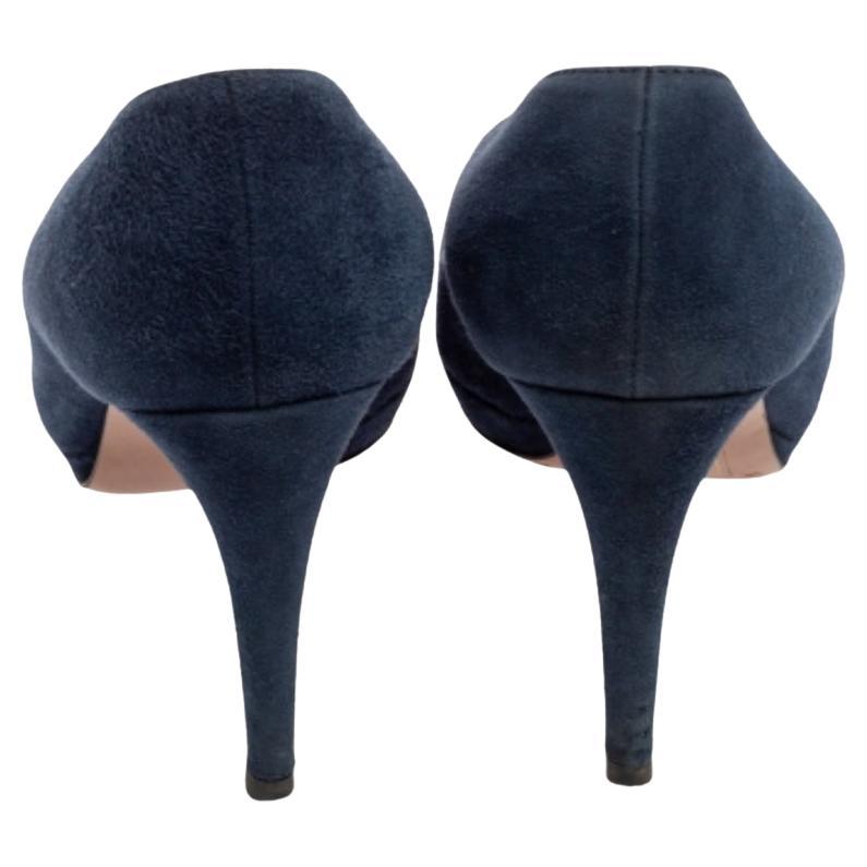 These pumps from the House of Prada will certainly make you look classy and polished! They are created using navy-blue suede on the exterior. They showcase peep-toes, platforms, and a slip-on style. They are finished with pointy heels. Look gorgeous