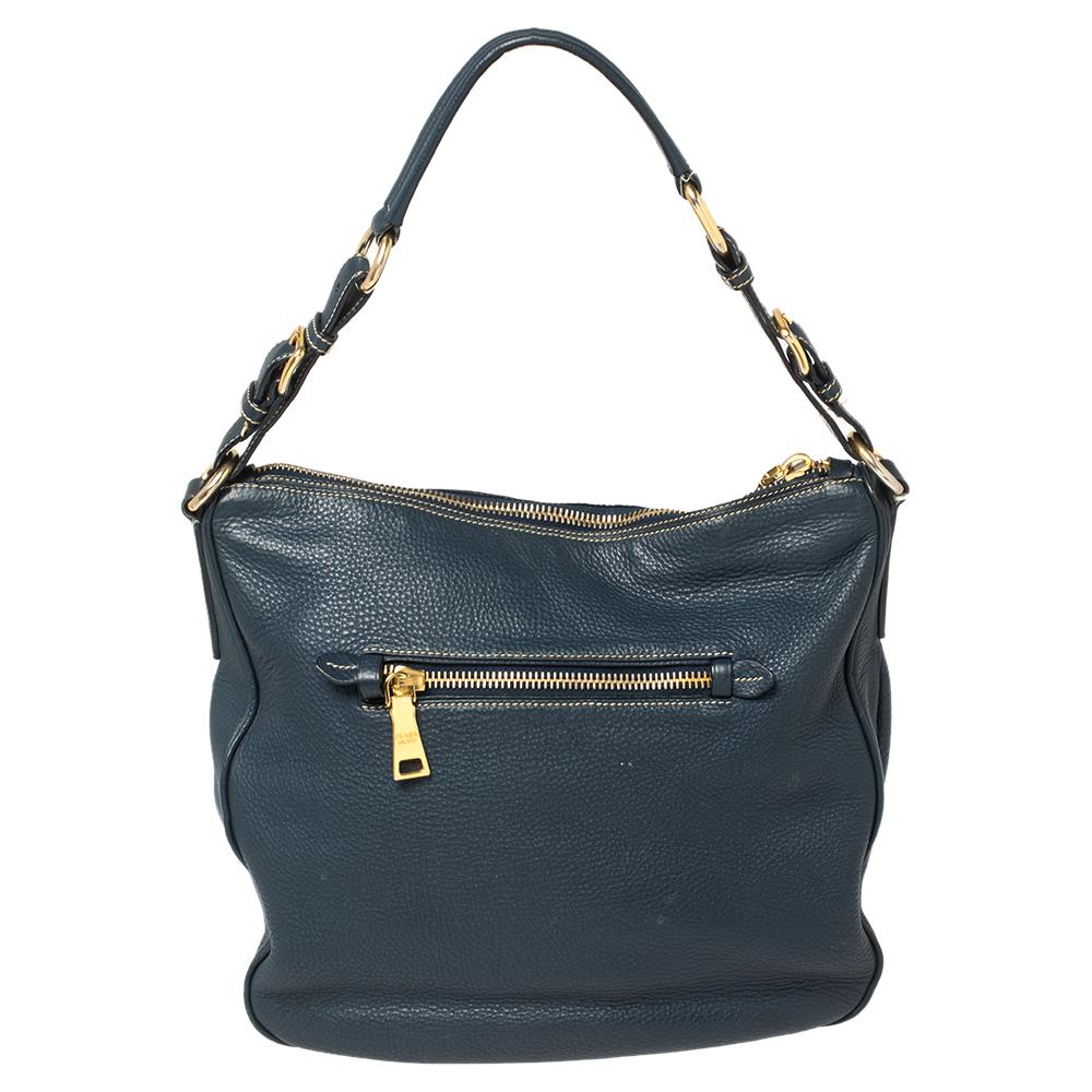 This elegant hobo from Prada is ideal for everyday use. Crafted from blue leather, the bag has a front zip pocket and a single top handle. The top opens to a spacious interior that is perfectly sized to hold all your necessities.

Includes: Original