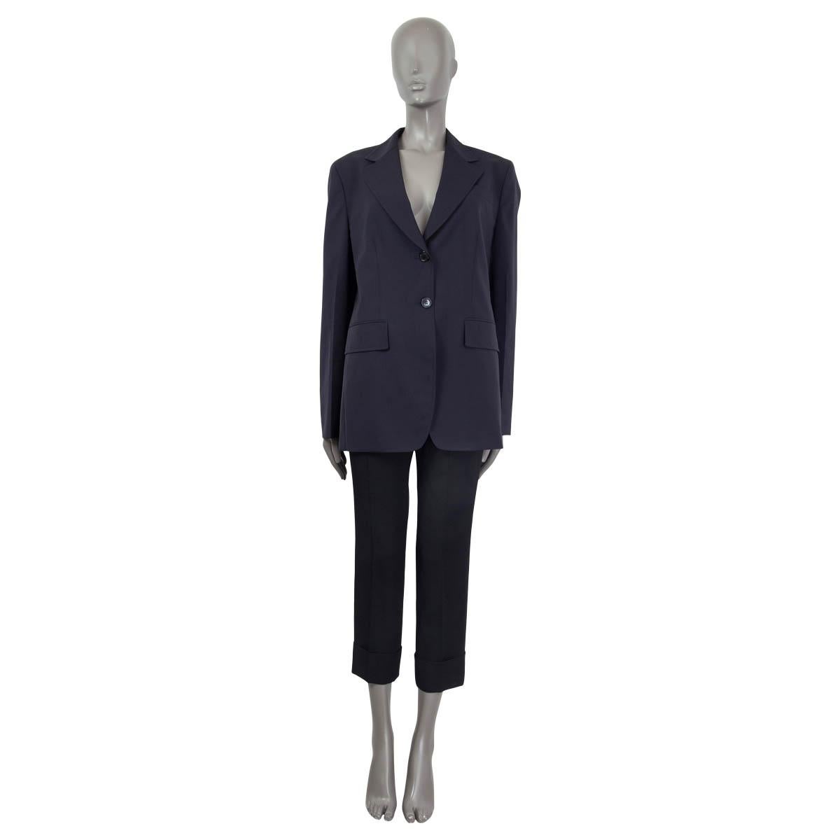 100% authentic Prada lightweight single breasted notched collar blazer in navy virgin wool (100%). Lined in navy polyester (100%). Opens with two buttons in the front. Features two front patch pockets. Has been worn and is in excellent