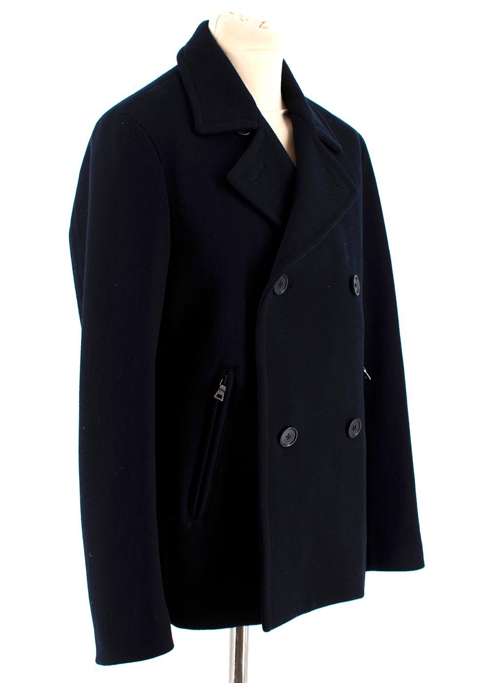 Prada Navy Blue Wool Peacoat

- Fully lined
- Double breasted
- Interior pockets
- Two exterior zipped pockets

Materials:
100% Virgin Wool

Made in Italy
Professional Dry Clean

Measurements:
Approx. 
Shoulders 44cm
Sleeves 65cm
Chest 52cm
Length