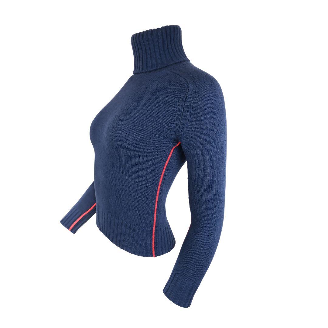 Extremely soft and warm cashmere turtleneck sweater with red trim details.

The contrasting bright red piping extends along the entire inner sides of the body and trails along the inner arms to the edge of the cuffs.

The sweater features