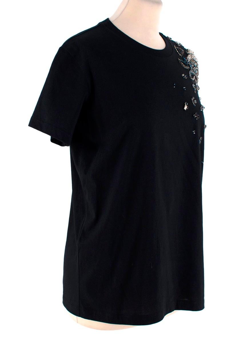 Prada Navy Cotton T-Shirt with Crystal Embellished Shoulder
 

 - Round neck, short sleeve t-shirt with classic fit
 - One shoulder ornamented with an abstract floral design crafted from silver and blue crystals 
 

 Materials 
 100% Cotton 
