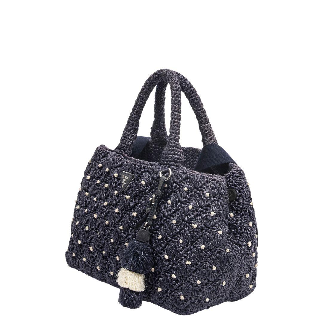We love this laid back beauty with ample space and the perfect crochet motif! Crafted in crocheted raffia, in a gorgeous navy tone, with silver-tone hardware, and an open top. The tassel is super cute!! The interior is tonal navy with one zippered