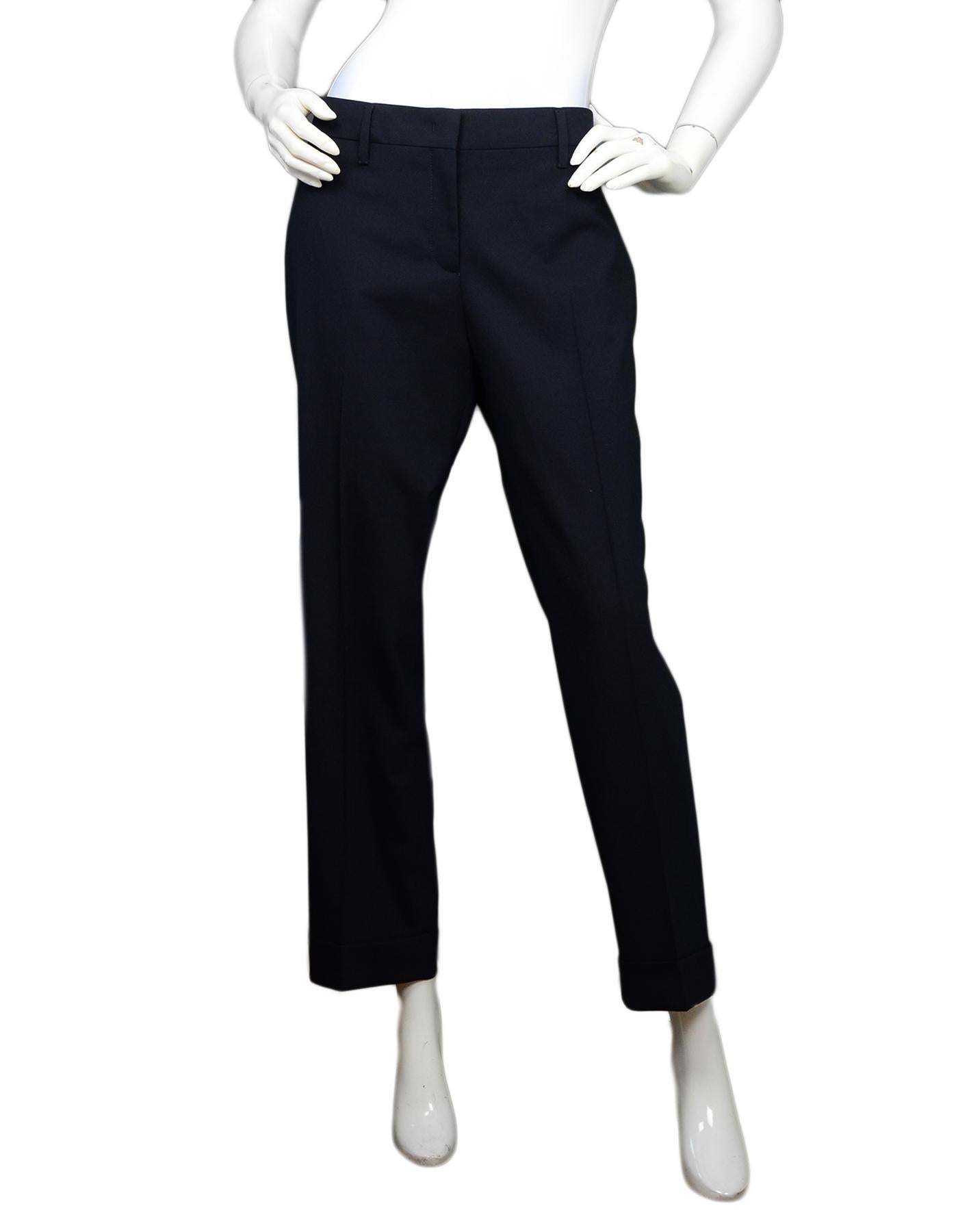 Prada Navy Natte Stretch Wool Trousers NWT Sz IT48/US12

Made In: Romania 
Color: Navy
Materials: 98% wool, 2% elastane 
Closure/Opening: Zipper and button front
Overall Condition: Excellent condition with original tags attached 
Estimated Retail: