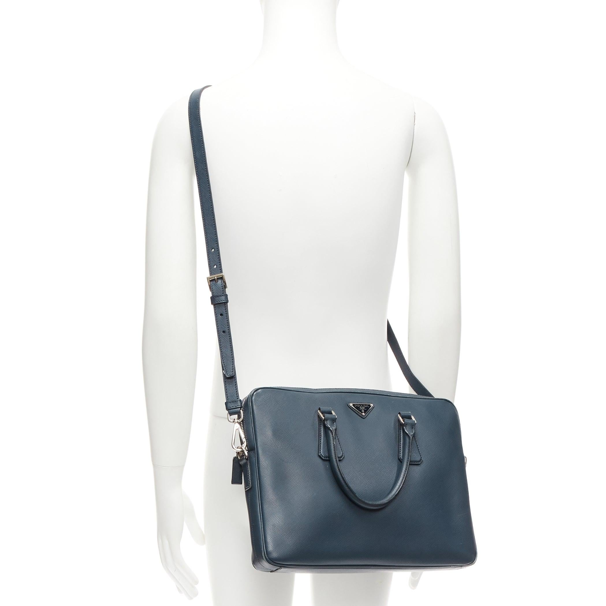 PRADA navy saffiano leather triangle logo plate crossbody top handle briefcase
Reference: TGAS/D00901
Brand: Prada
Designer: Miuccia Prada
Material: Leather
Color: Navy, Silver
Pattern: Solid
Closure: Zip
Lining: Black Fabric
Extra Details: