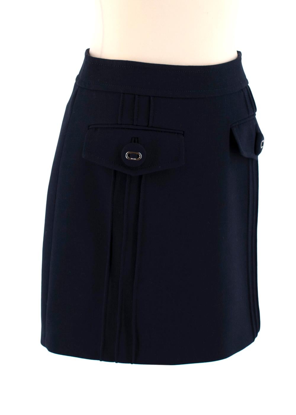 Prada Navy Wool Mini Skirt

-Timeless mini skirt made of navy virgin wool
-Front flap pockets with silver tone logo-embellished button detailing
-Hidden zipper along back hem
-Tonal stitching
-Fully lined
-Non-stretch material
-Classic, elegant