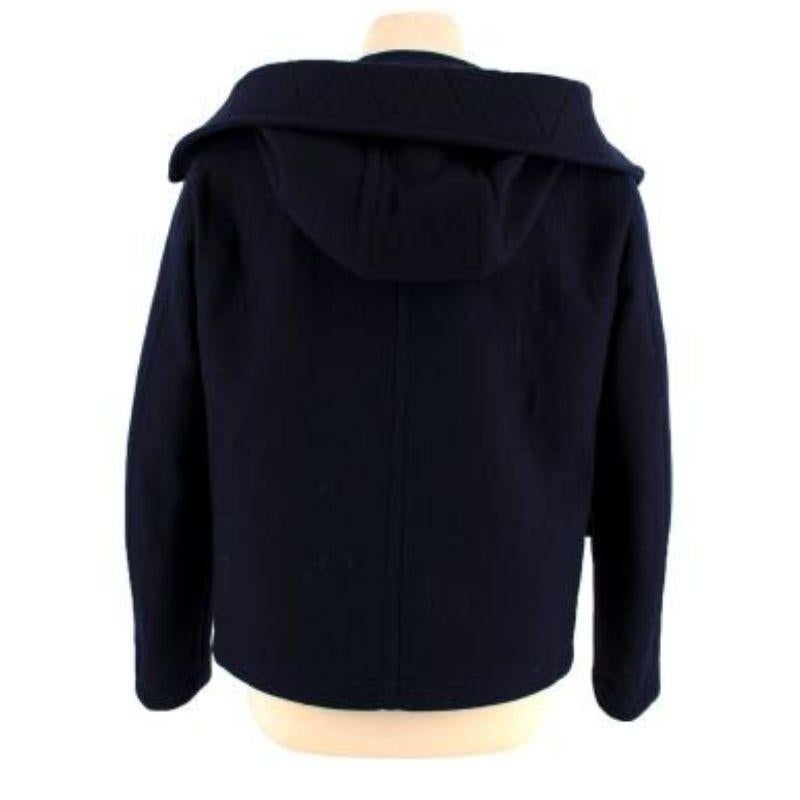 Prada Navy Wool Hooded Coat

-Snap button & Zip fastening 
-Hooded 
-Adjustable collar draw strings 
- Four pocket style 
-Unlined
-Heavy weight construction 

Material: 

100% Wool 

Made in Italy 

PLEASE NOTE, THESE ITEMS ARE PRE-OWNED AND MAY