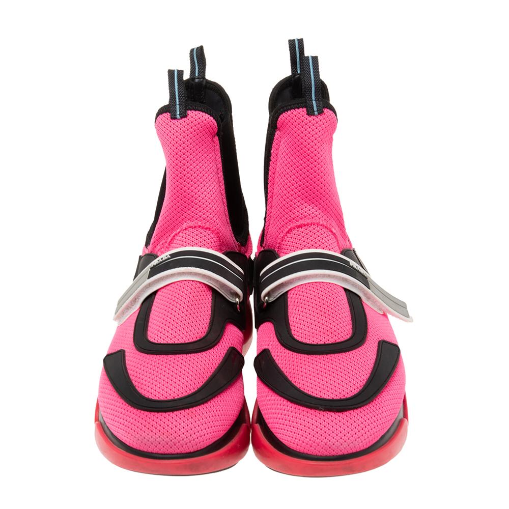 Let your latest shoe addition be these amazing Cloudbust sneakers from the House of Prada. They are crafted using pink-black mesh and rubber trims into a high-top silhouette. Their vamps are adorned with brand detailing. Elevate your style by
