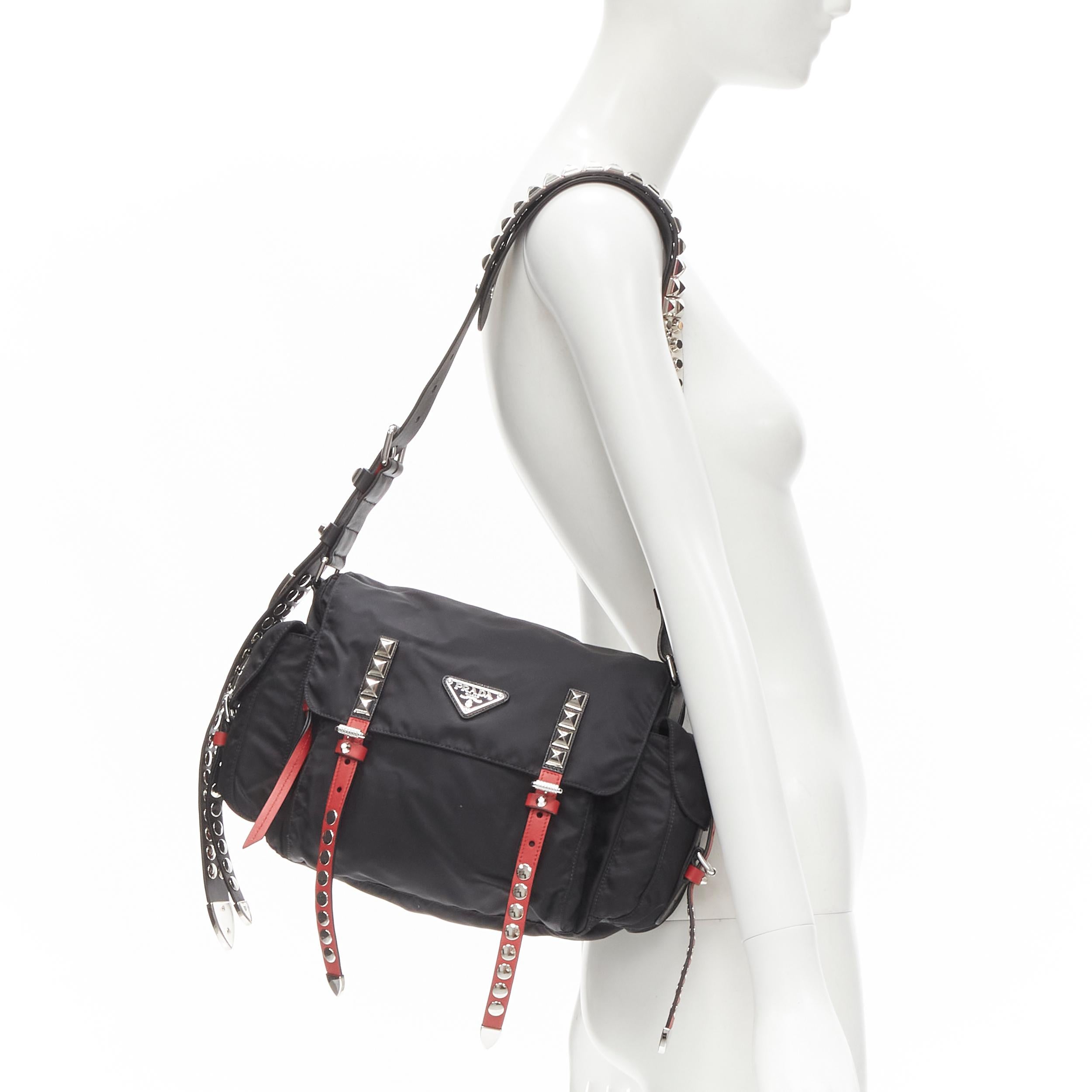 PRADA New Vela Tessuto black nylon punk studded mesenger bag 
Reference: ANWU/A00020 
Brand: Prada 
Designer: Miuccia Prada 
Model: New Vela 
Material: Nylon 
Color: Black 
Pattern: Solid 
Closure: Buckle 
Extra Detail: Adjustable leather shoulder
