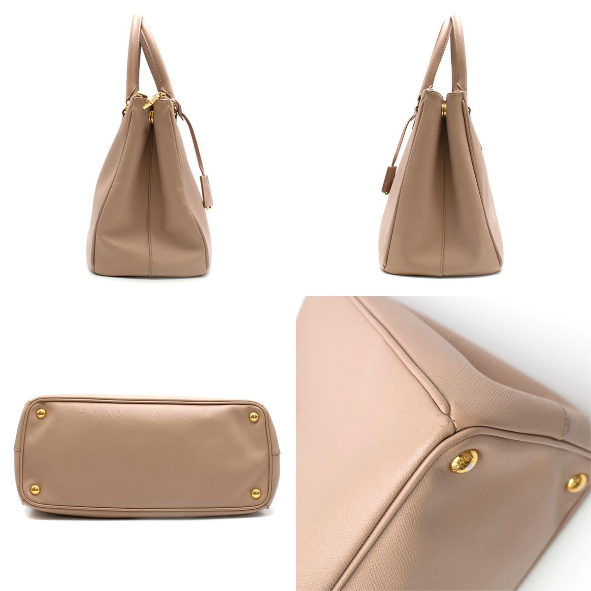 Prada Nude Galleria Large Saffiano Leather Bag

- This deluxe Prada bag is a fan favourite in the fashion world
- This satchel features a saffiano leather body
- Rolled leather handles, a detachable flat leather strap
- An open top with magnetic