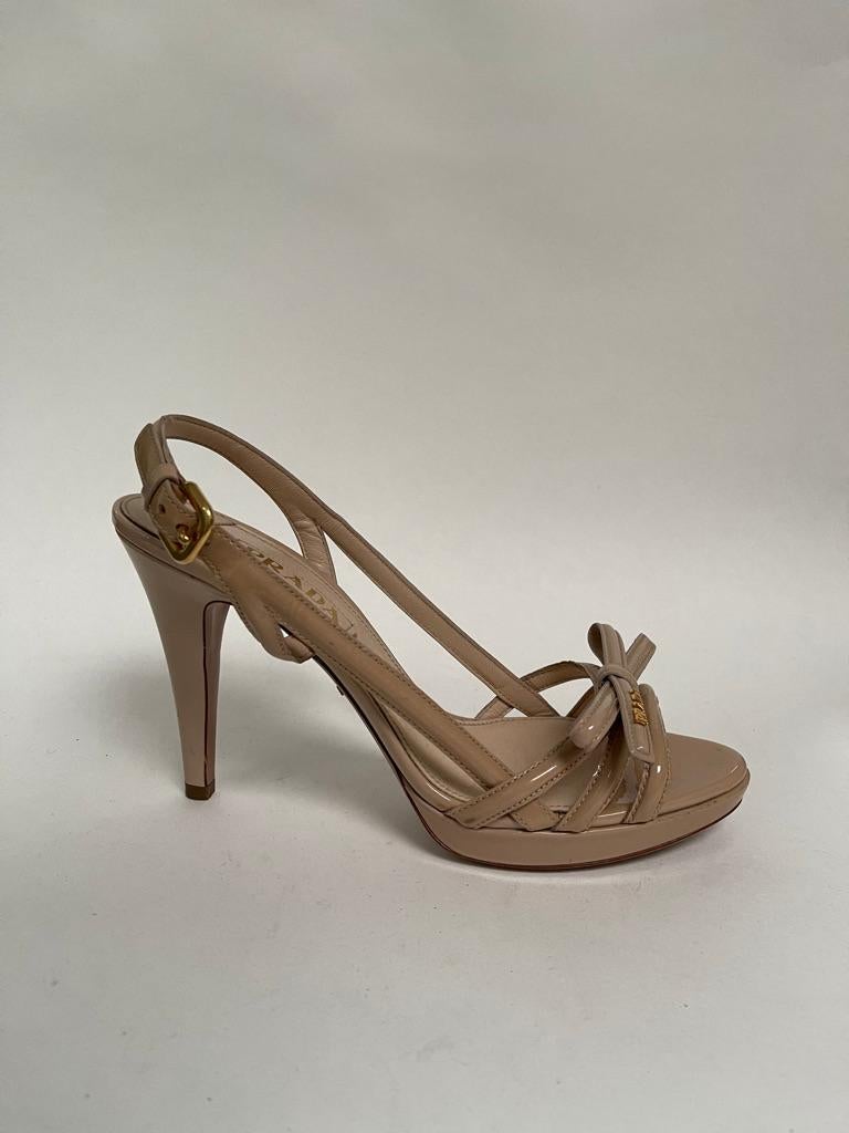 patent leather nude sandal with gold prada logo on toe