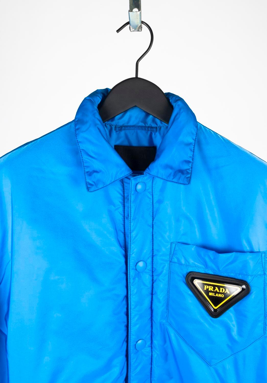 100% genuine Prada Nylon blue jacket, S641 
Color: blue
(An actual color may a bit vary due to individual computer screen interpretation)
Material: 100% nylon
Tag size: M runs relaxed fit, oversized Medium
This jacket is great quality item. Rate 9