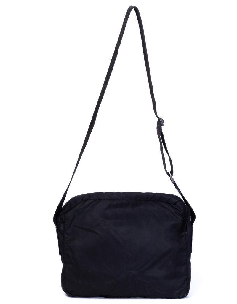 This crossbody bag features a nylon body, an adjustable flat shoulder strap, top zip closure, and an interior zip pocket.

COLOR: Black
MATERIAL: Nylon
ITEM CODE: 79
EST. RETAIL: CA$1495
MEASURES: H 9” x L 11” x D 4”
CONDITION: Exterior, Interior