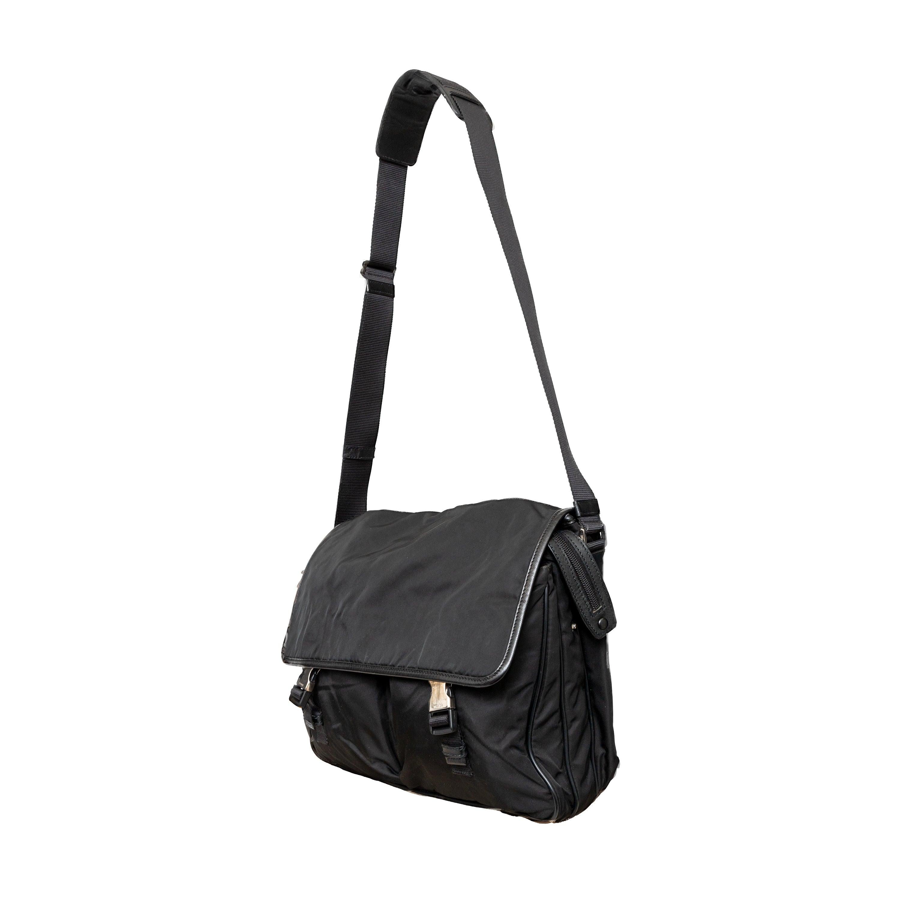 This black re-nylon messenger bag with trim features dual buckle closures on pockets, a side lock, and an enamel triangle signature brand emblem for a sleek finish.
 Inclusion: dust bag
 Remarks: there are some signs of wear on the hardware. 
