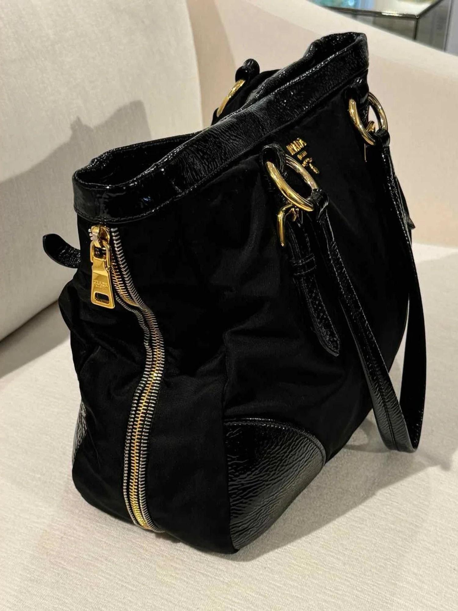 Color: Black with gold tone hardware
Material: nylon with leather details and finishes
Condition: Good. Light scratches throughout, 
Made in Italy

Measurements~
Height 10”
Length 14”
Depth 5”
Drop: 11”