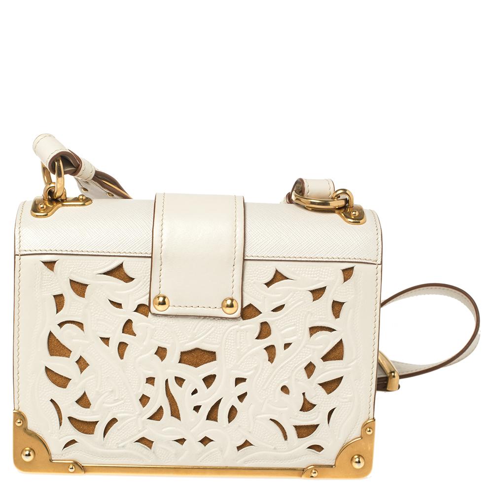 Diese prächtige Tasche von Prada wirkt königlich und hat eine strukturierte Silhouette. Sie ist aus Leder in einem cremefarbenen Farbton gefertigt und strahlt italienische Handwerkskunst aus. Die Kreation ist mit goldfarbener Hardware und