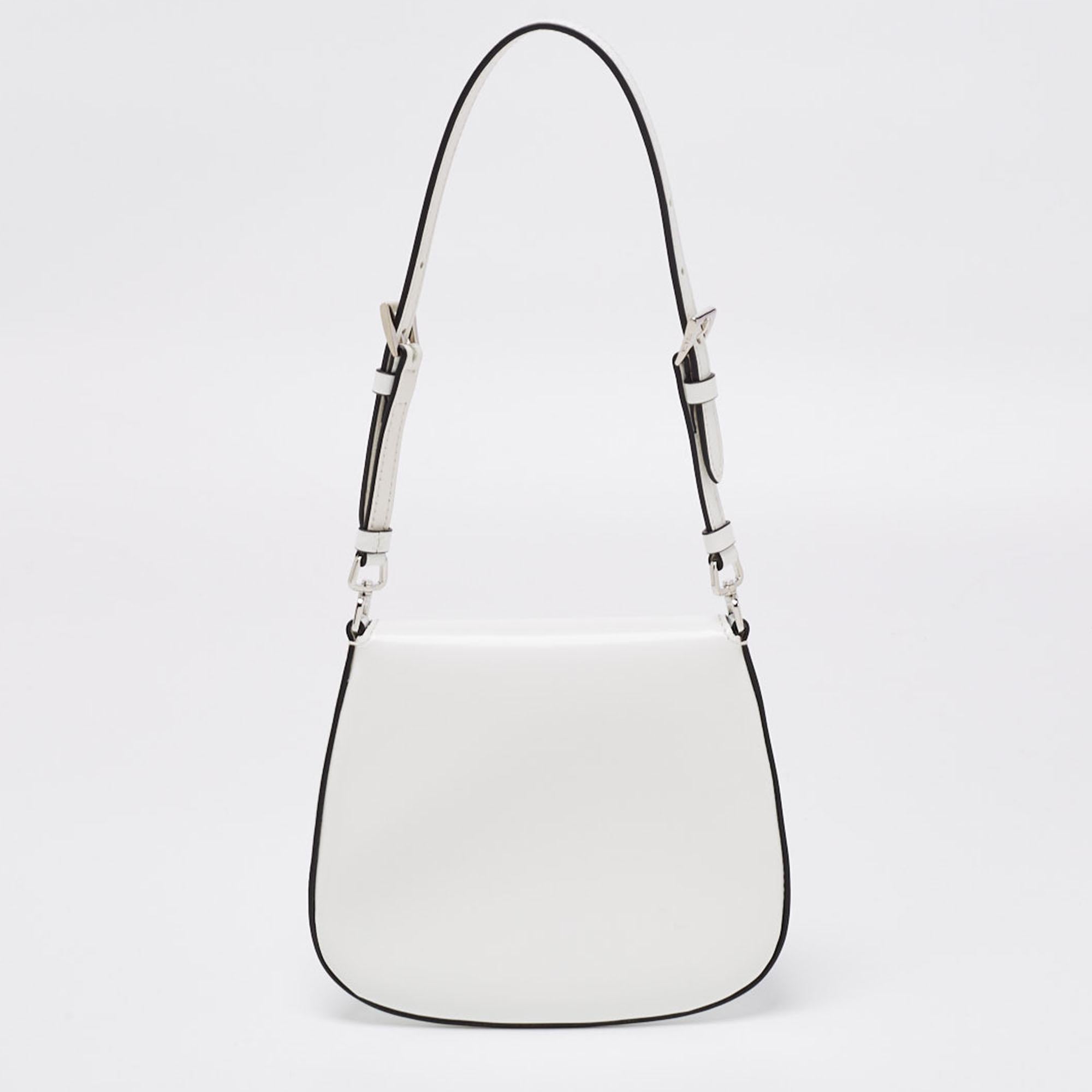 We've found the perfect mini bag for the season. It is this Prada mini Cleo pochette in off-white leather. It has a branded flap and a nylon interior to house your cardholder, keys, lipstick, earphones, and gum.

Includes: Authenticity Card, Info