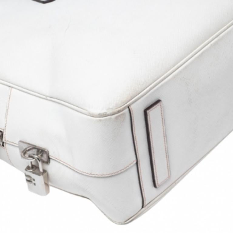 This elegant Bauletto bag from Prada is crafted from Saffiano leather and is perfect for work or travel. It features dual top handles, silver-tone hardware, and a nylon-lined interior.