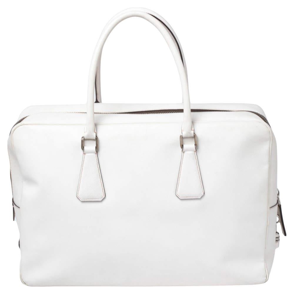 This elegant Bauletto bag from Prada is crafted from Saffiano leather and is perfect for work or travel. It features dual top handles, silver-tone hardware, and a nylon-lined interior.

Includes: Original Dustbag, Numeric Padlock, Leather Name Tag

