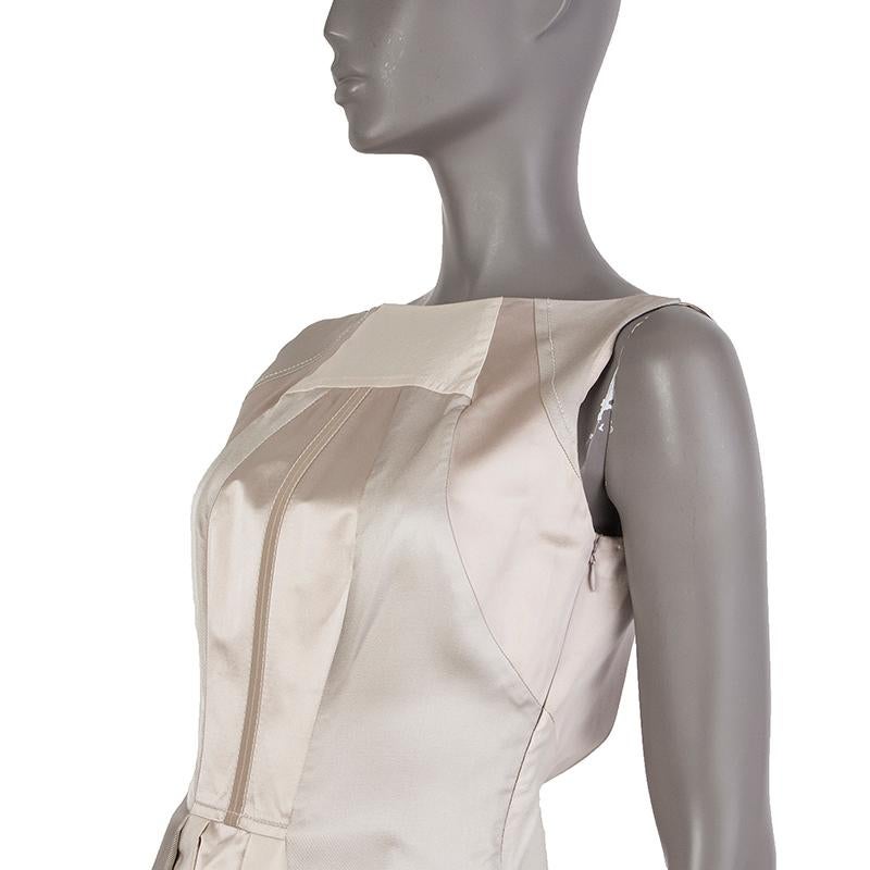 Prada pleated dress in champagne, silver, and off-white wool (57%) and silk (43%). With wide neck and scoop back. Closes with hook and invisible zipper on the back. Lined in nude silk organza (100%). Has been worn and is in excellent condition.