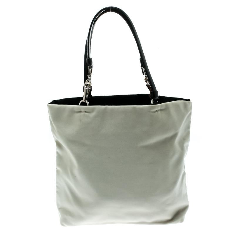 Stylish and reliable, this tote is from the house of Prada. It is crafted from nylon and has an open top that leads to a well-sized interior. You can carry this off-white piece using the dual handles.

Includes: Original Dustbag


