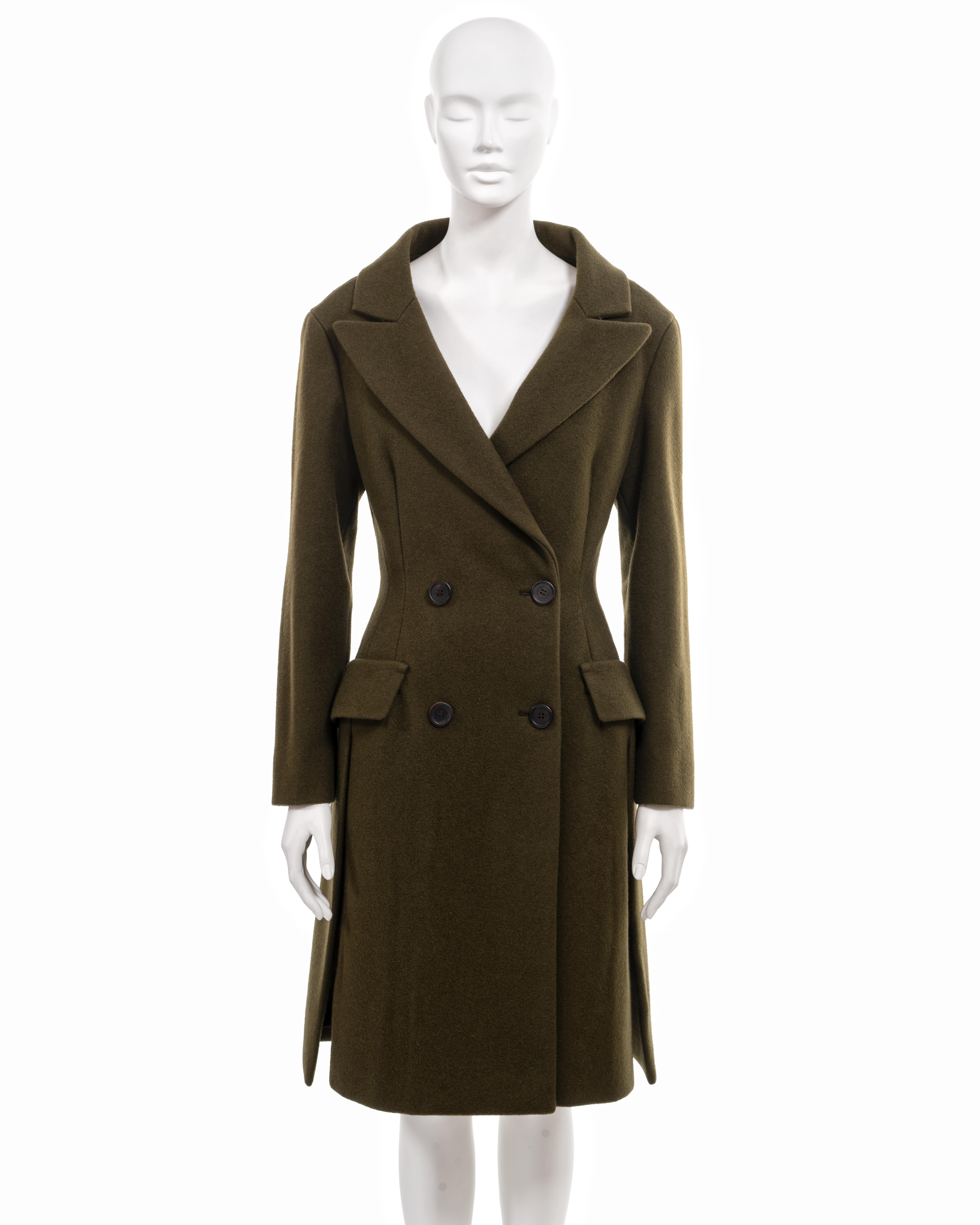 ▪ Prada archival coat
▪ Creative Director: Miuccia Prada 
▪ Sold by One of a Kind Archive
▪ Constructed from high-quality olive green melton wool 
▪ Stand-away collar with peak lapels 
▪ Multiple vertical darts accentuate the waist 
▪