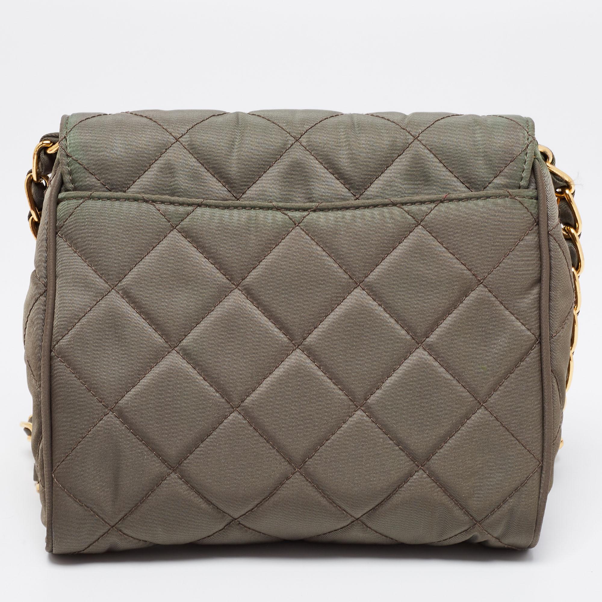 This crossbody bag from Prada is a perfect balance of elegance and practical utility. The olive green bag has a quilted exterior and flaunts an interwoven chain strap. It features a push-lock closure that leads to a well-sized interior capable of