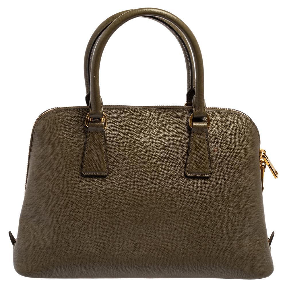 This stunning Promenade tote is high on appeal and style. Dazzling in a classy green shade, the bag is crafted from leather and features two rolled handles. The zip closure leads way to a nylon interior with enough space for your essentials and the