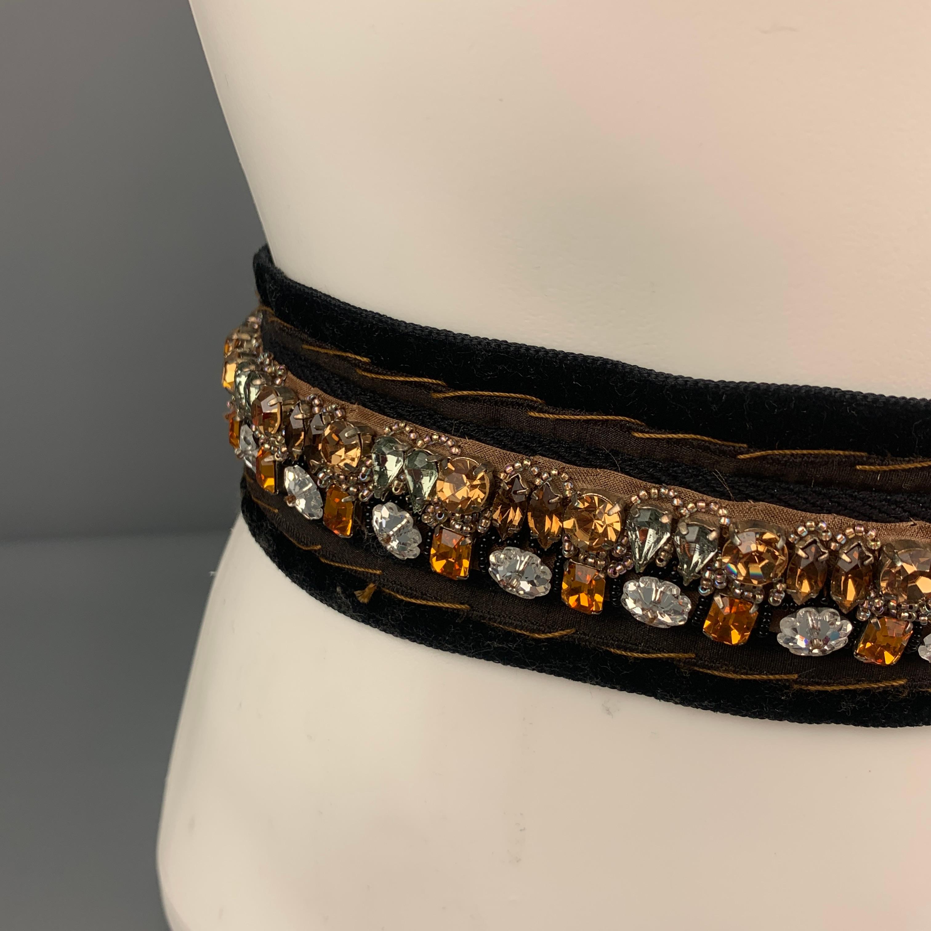 PRADA belt comes in a black velvet featuring rhinestone embellishments and a self tie canvas strap. Comes with box. Made in Italy. 

Very Good Pre-Owned Condition.

Length: 66 in.
Width: 2 in. 