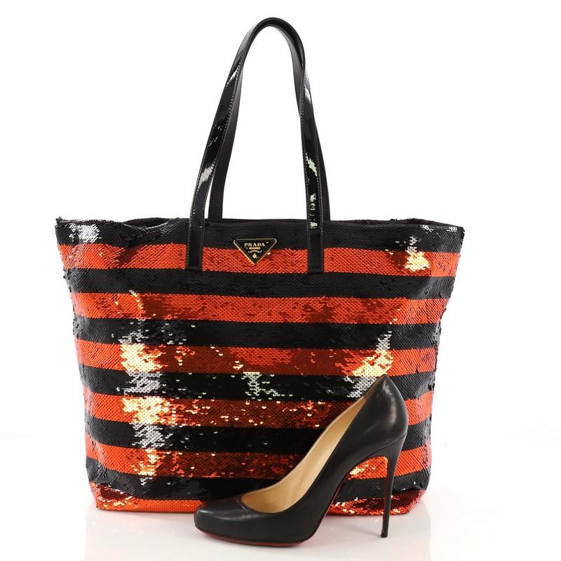 This Prada Open Tote Sequins Large, crafted in black and orange striped sequins, features dual flat patent leather handles, inverted triangle Prada logo on front, and gold-tone hardware. It opens to a black satin interior with zip pocket. **Note: