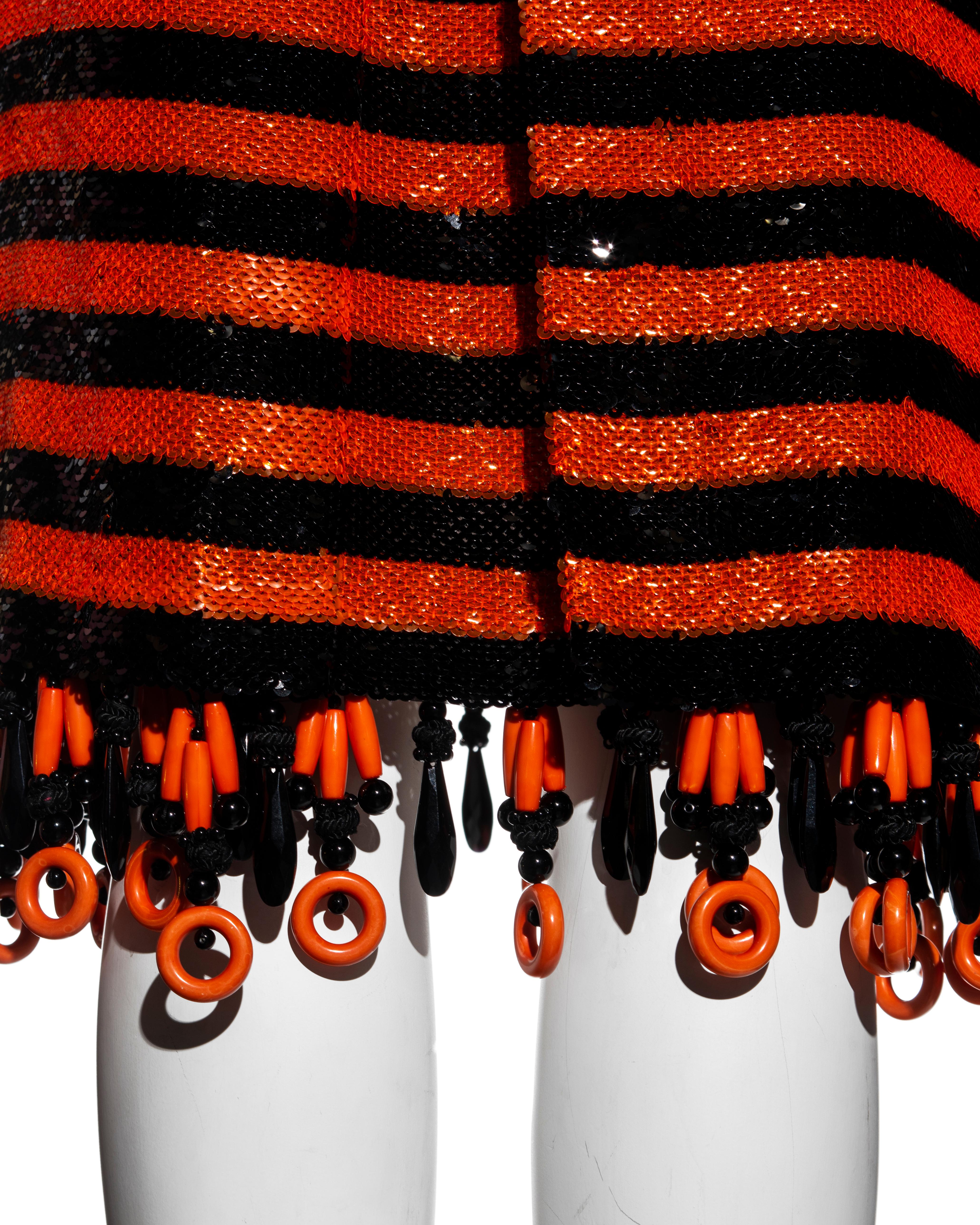 Women's Prada orange and black striped sequin flapper dress and fox fur stole, ss 2011