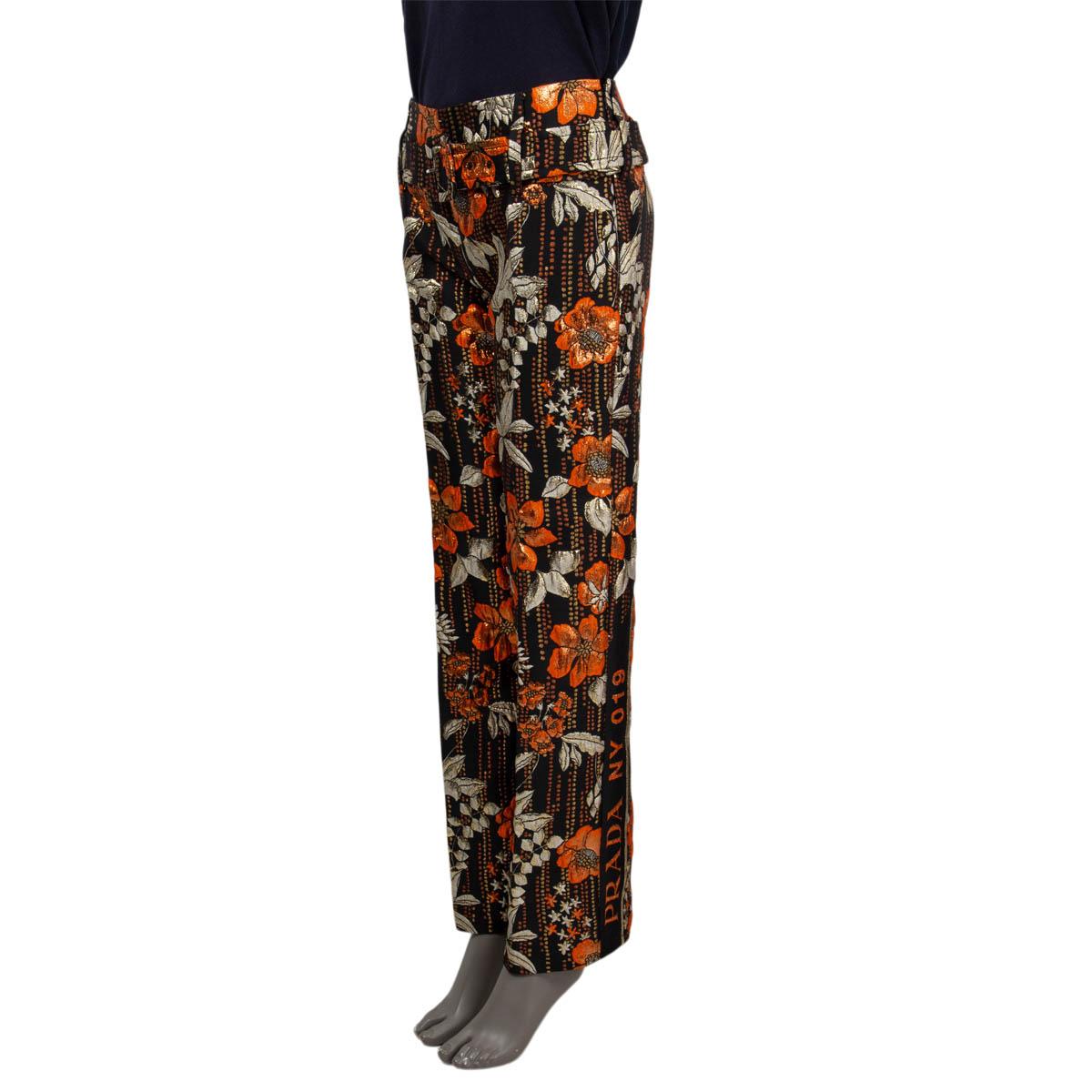 100% authentic Prada floral-cloqué wide-leg pants in orange and black polyester(59%), acetate  (25%), silk (10%) and polyamide (6%). Features belted and brocade, on the side Prada lettering. Closes with a concealed zipper. Has been worn and is in