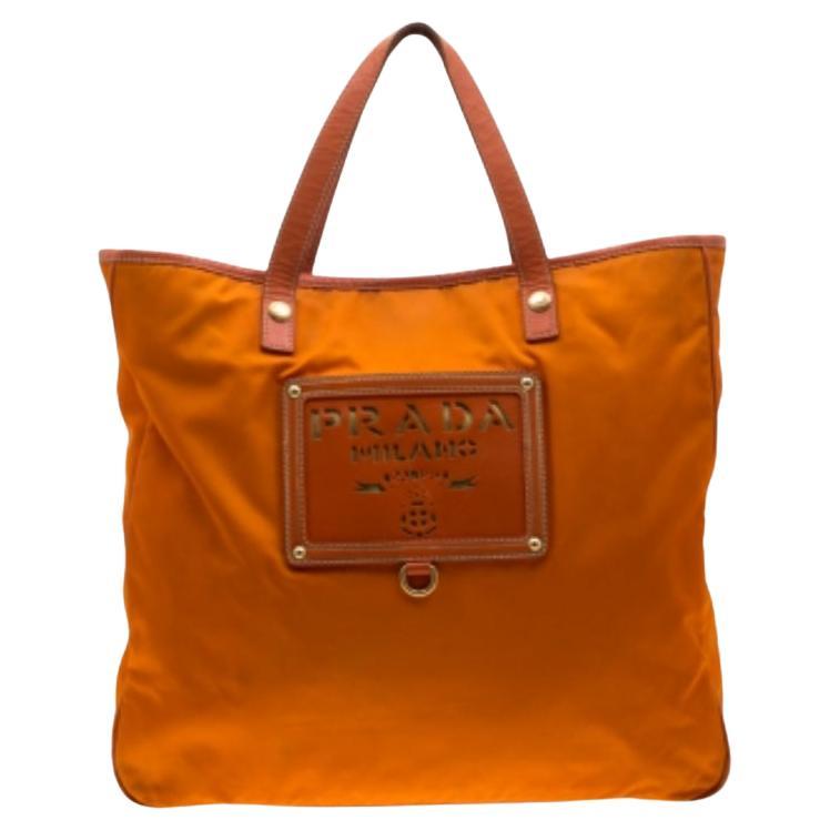 Prada, borsa arancione in nylon e pelle con logo tagliato a laser