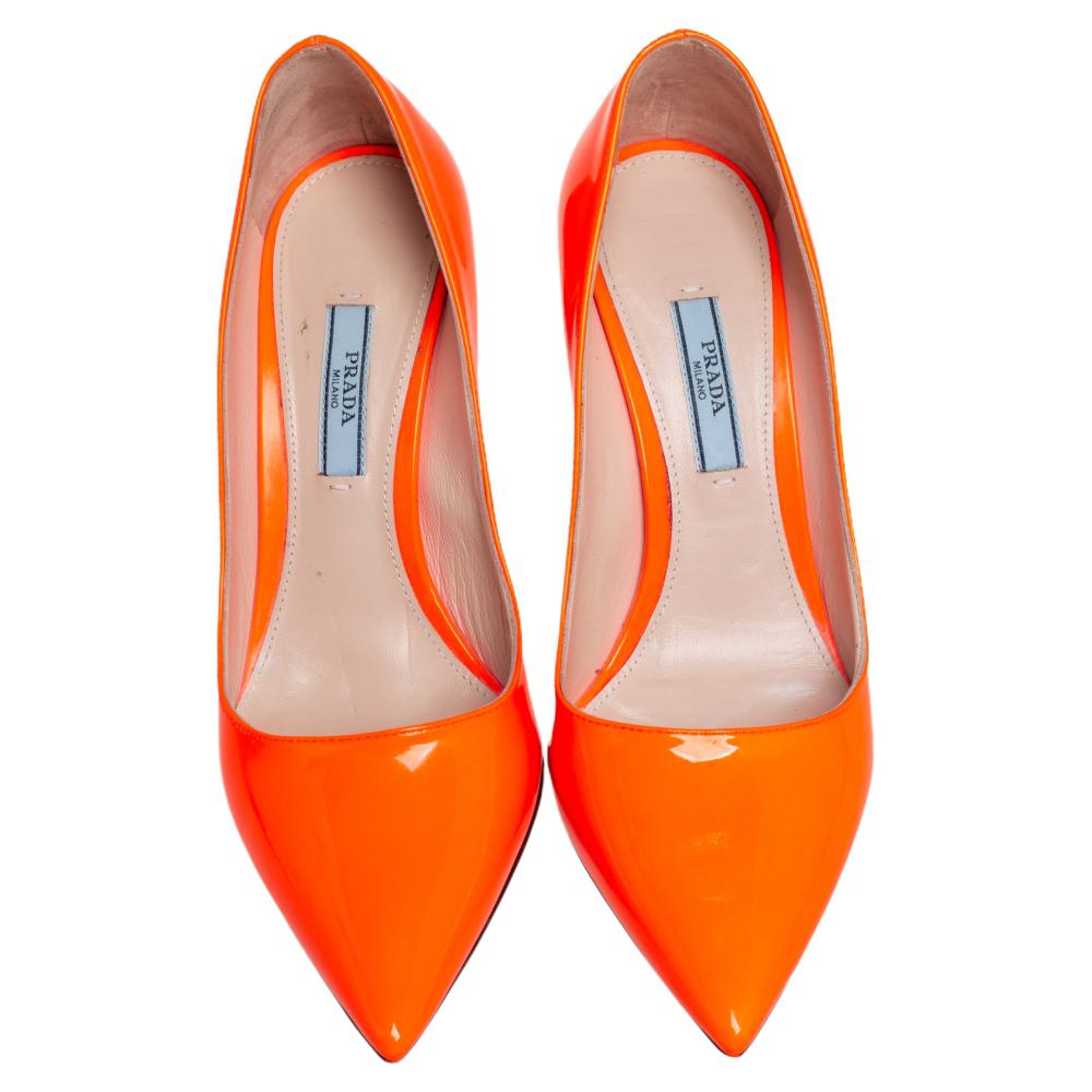 Adorn the modern chic look by flaunting this pair of exquisite Prada pumps. Dance comfortably and gracefully in this pair adorned in an orange hue exuding a smooth finish. Live to your best while flaunting these pumps, crafted from patent leather,