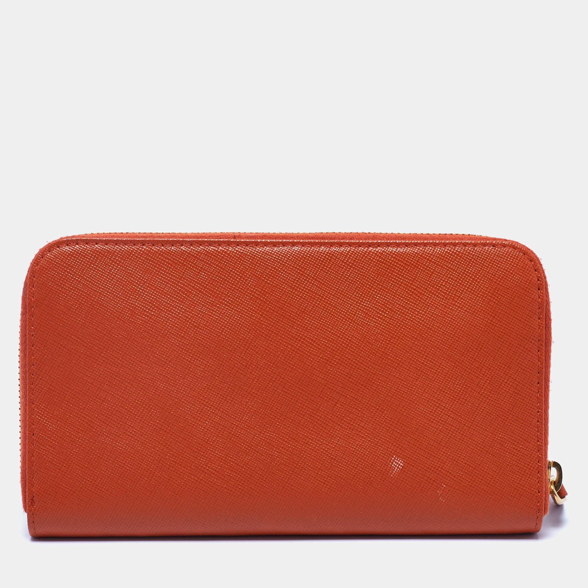 Sewn beautifully in every detail, this continental wallet from Prada stands for resistance and durability. This wallet features an exterior made from Saffiano leather with a gold-toned logo lettering decorating the front. It has a zip-around feature