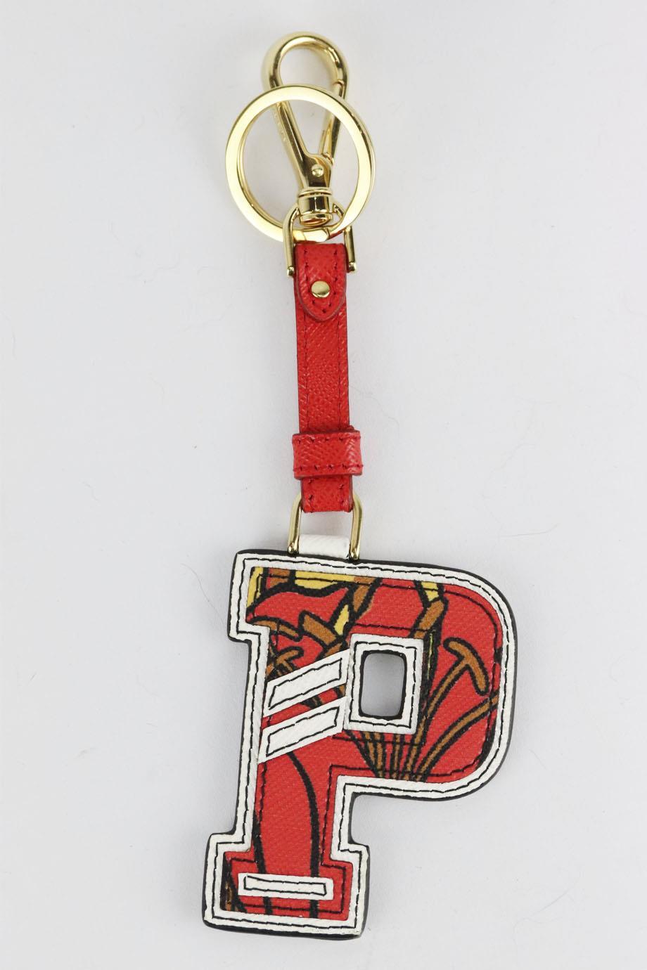 Prada 'P' initial printed textured leather bag charm. Red, brown, yellow and white. Lobster clasp fastening at top. Does not come with dustbag or box. Height: 7 in. Width: 2.2 in
