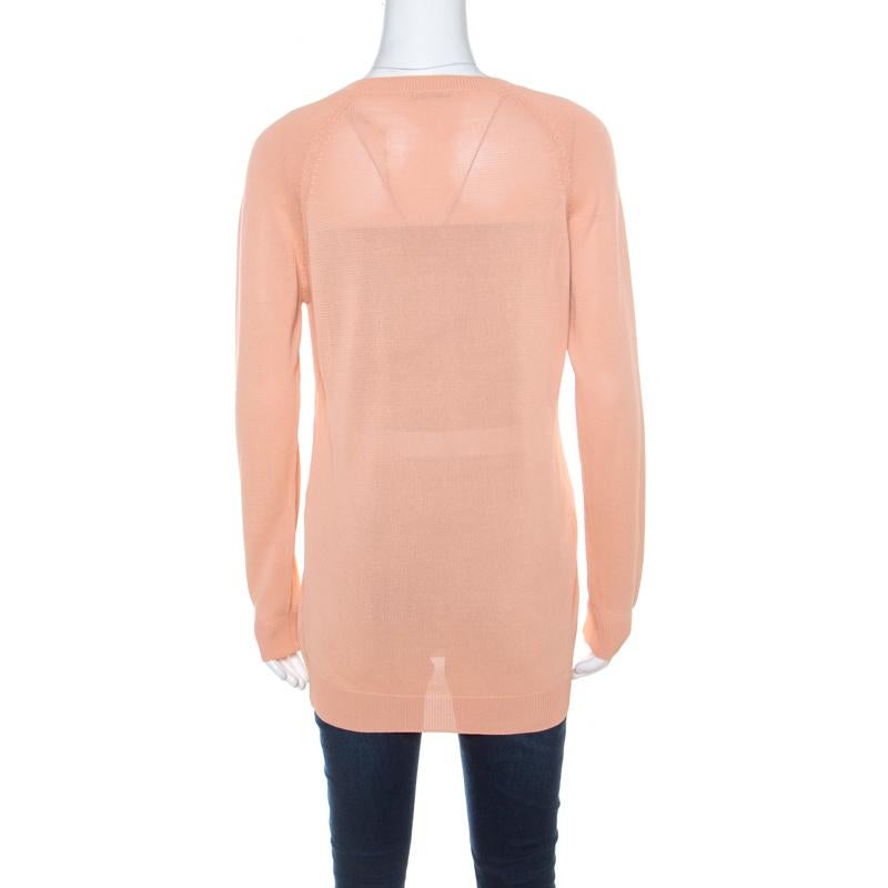 Prada's pullover is a fine combination of subtle style and feminine details. It is tailored in quality fabrics and has a plunging neckline, long sleeves and a loose silhouette. Team it with a variety of bottoms for a fun look.

