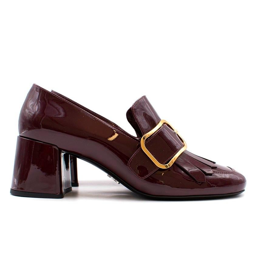 Prada Patent Heeled Loafers

- Burgundy patent leather
- Gold-tone large buckles to the front of both shoes
- Frill detail
- Mid block heel
- Nude insole with Prada embroidered logo label
- Black sole with Made in Italy and sizing embossed
-