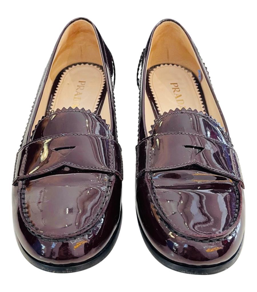 Prada Patent Leather Loafers
Burgundy slip-on loafers designed with zig-zag trim and tonal stitching throughout.
Featuring tonal strap at vamp, round toe, and low stacked heel.
Size – 40
Condition – Good/Very Good (General signs of wear,