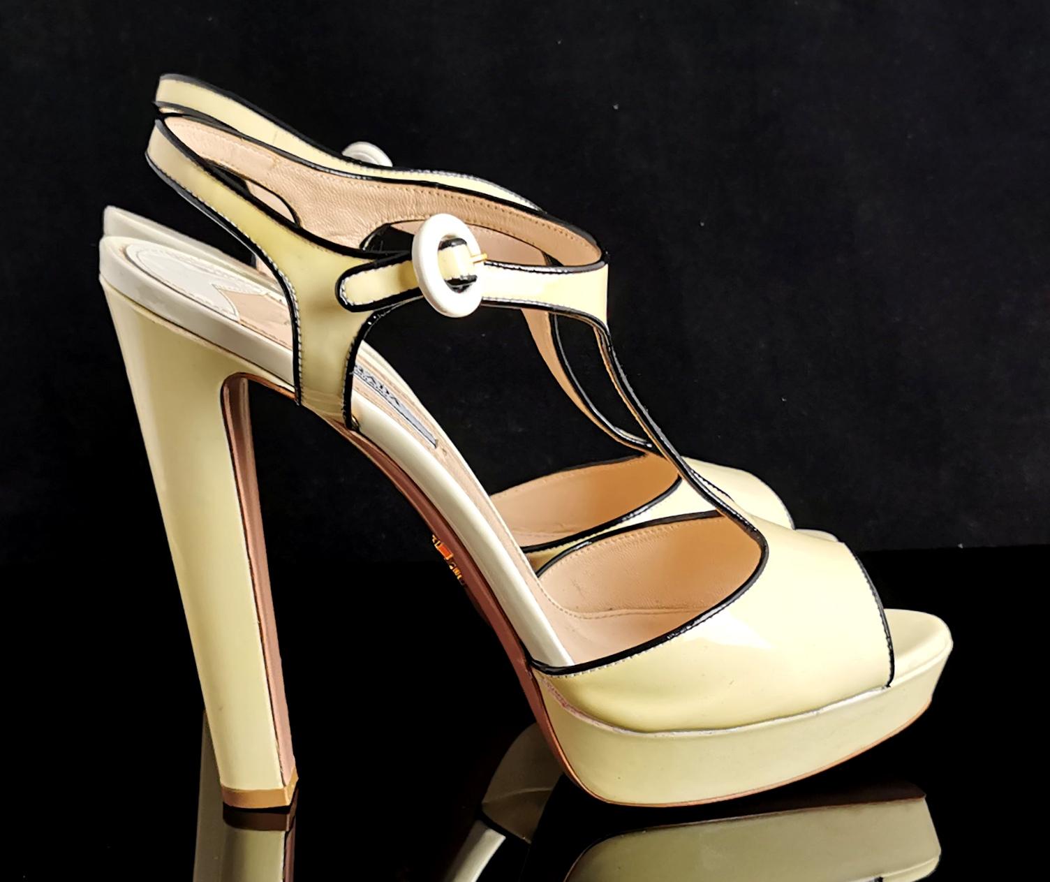A truly gorgeous pair of Prada patent leather platform heel sandals.

They have a T bar shape with chunky platform soles and sky scraper heels giving the perfect legs forever look whether worn with your favourite jeans or dressed up for an evening