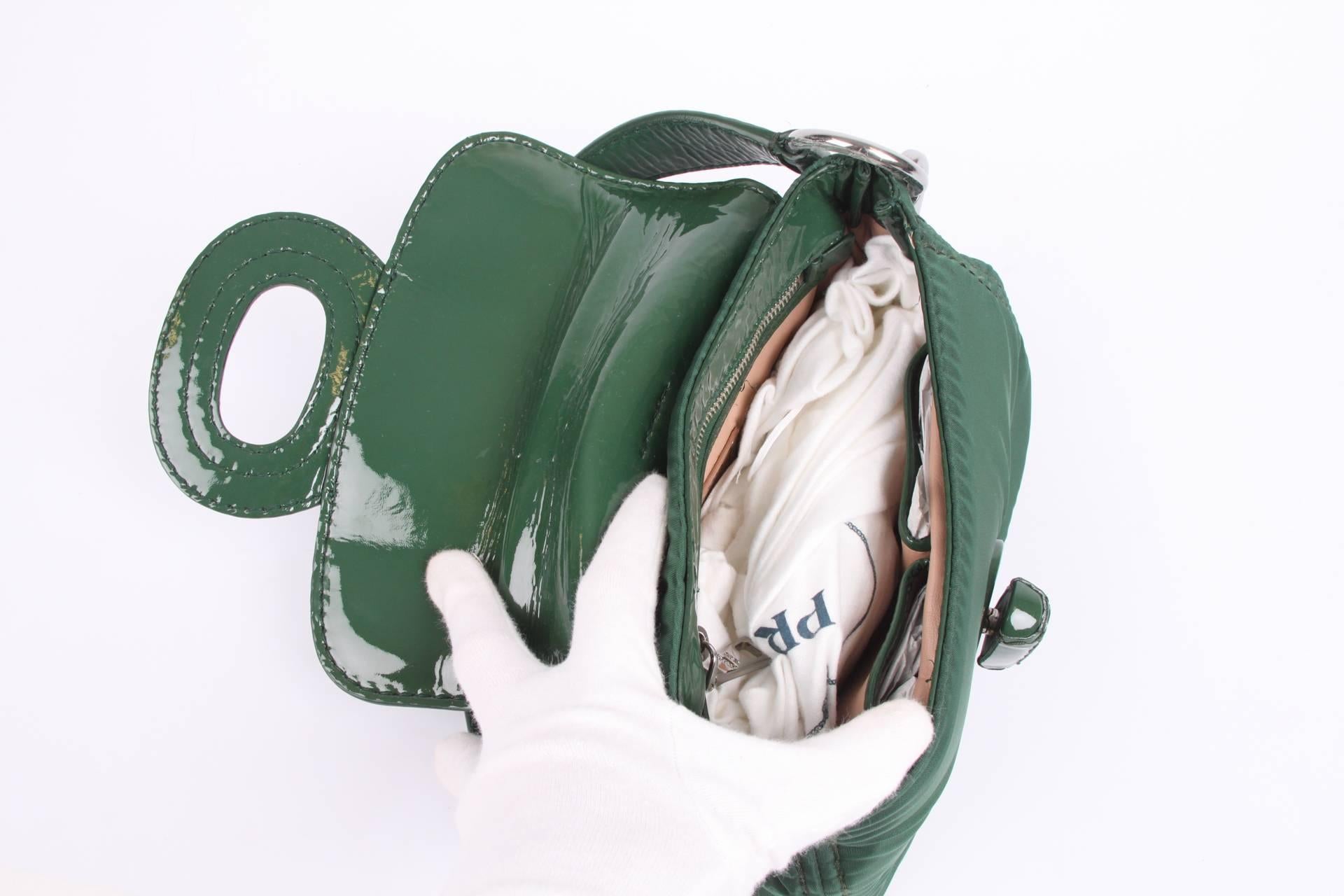 Practical shoulder bag by Prada; this is the Pattina Sottospalla Handbag in emerald green.

Crafted in nylon with patent leather detailing and silver-tone hardware. Large fold-over twist lock closure at the front. A silver-tone logo label inside and