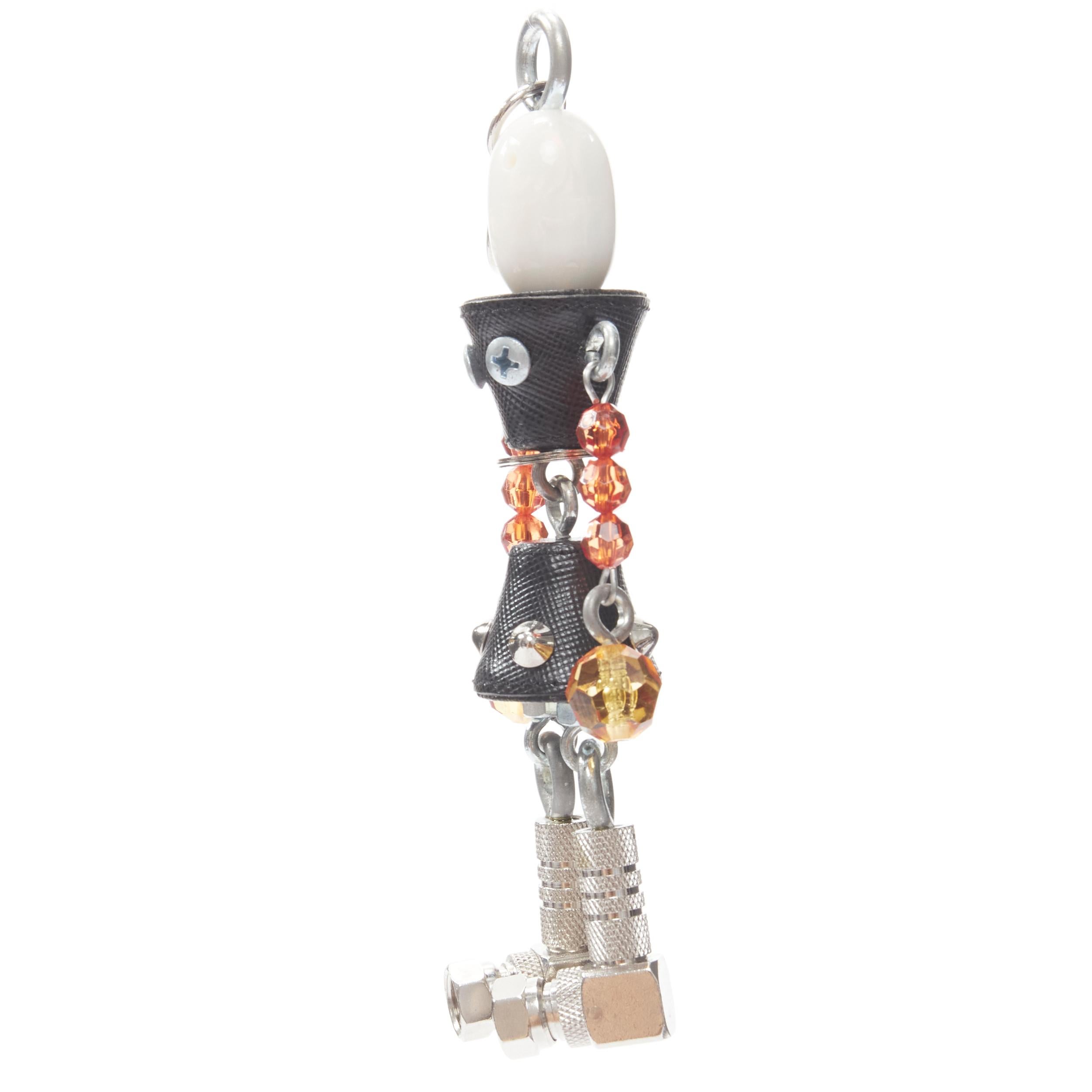 PRADA pearl resin head beaded arms saffiano bolt hardware keychain bag charm
Reference: TGAS/B01414
Brand: Prada
Designer: Miuccia Prada
Model: Robot charm
Material: Leather, Resin
Color: Black, Silver
Pattern: Solid
Extra Details: Pearlescent resin