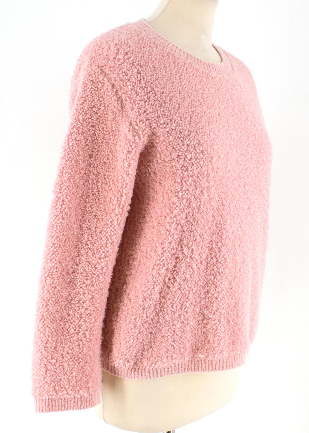 Prada Pink Alpaca-blend boucle sweater. Features a keyhole back with a button fastening and bracelet sleeves.

- Made in Italy 
- 54% Aplaca , 24% Polyamide, 22% Cotton

Shoulders 45 cm
Sleeves 49 cm
Length 55 cm