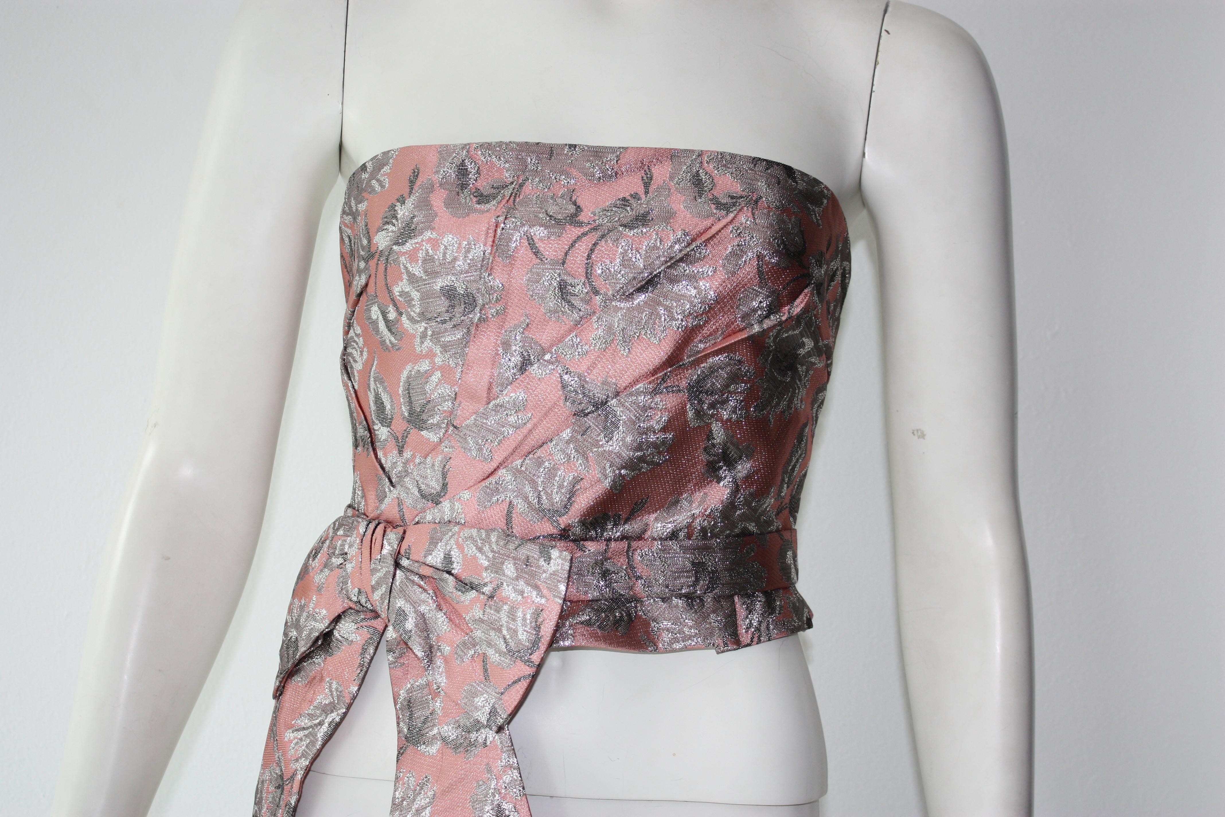 Prada pink and silver metallic strapless bustier. Front bow accent. 
Back zip. Crop length.  

Acetate, cotton, silk blend.
Size 40 (fits small - US 4 ) 
Excellent Condition 