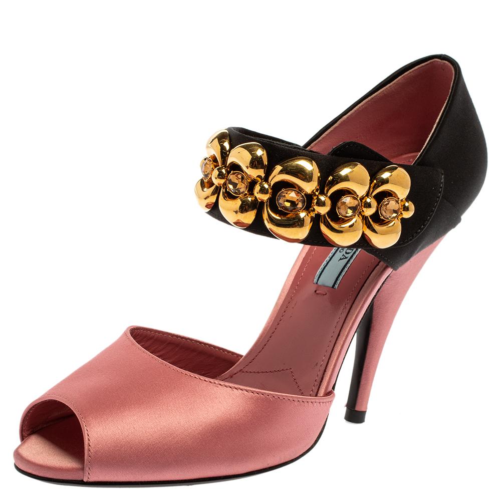 Put on these charming sandals from Prada and get set to step out in style. The satin sandals feature open toes, shades of pink and black, closed counters, and embellished ankle straps. They bring leather insoles featuring the brand name and 12 cm
